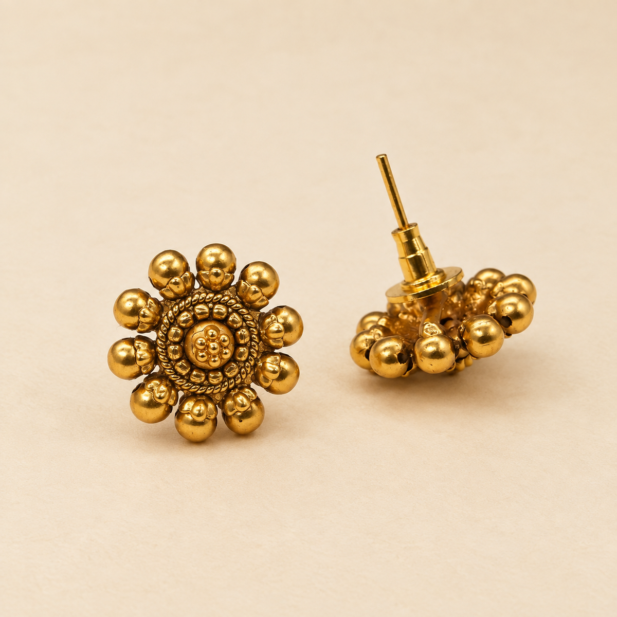 Close-up detail of antique gold flower stud earrings
