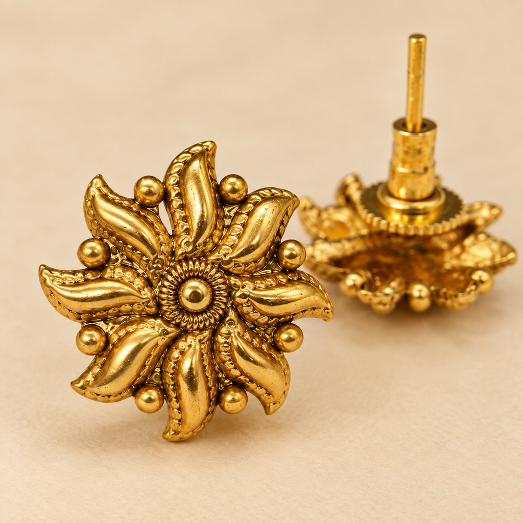 Close-up detail of antique gold leaf petal stud earrings